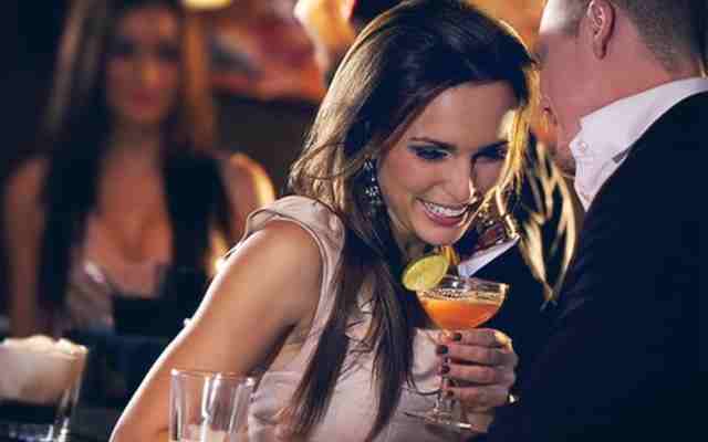 Confident Woman Flirting Sexy confident woman flirting with a man in a bar