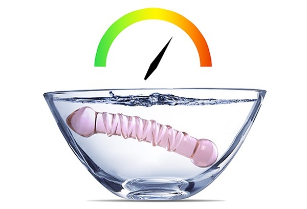 Glass dildo submerged in water Glass dildo in a bowl of water with temperature gauge graphic above it