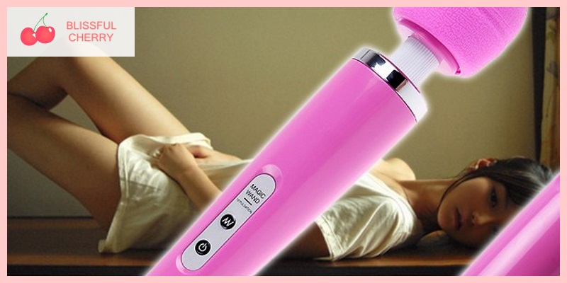Sex Toy Collection Woman lying on the floor with pink wand vibrator in foreground