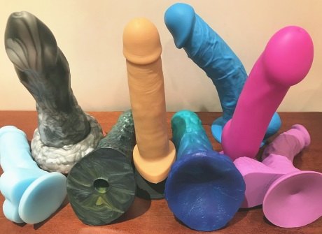 Variety of Dildos dildos of various shapes and colors on a table