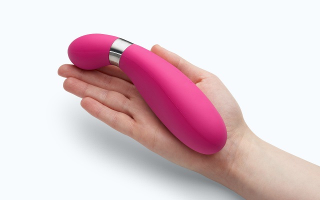 Vibrator in Hand Pink vibrator in palm of hand with white background