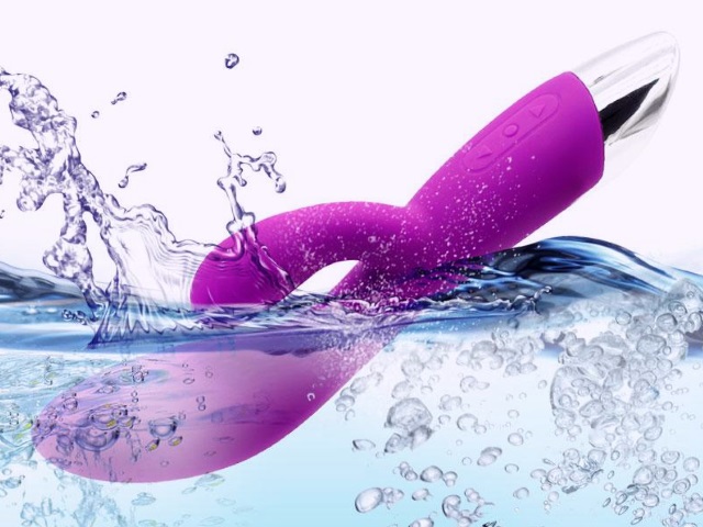 Vibrator In Water A purple vibrator being submerged into water